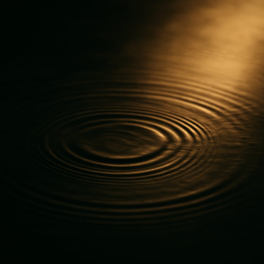 Gentle ripples spreading across still water in soft light