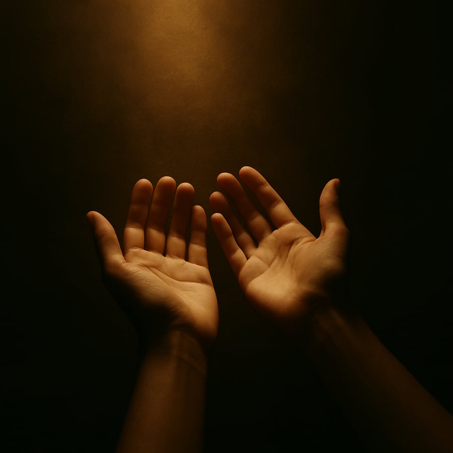 Open hands held upward in soft, warm light